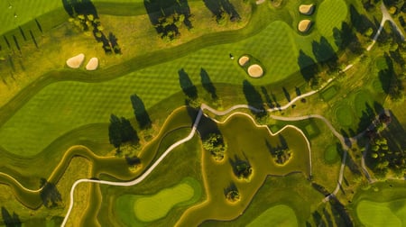 aerial-view-of-a-golf-course-covered-in-greenery-i-2023-11-27-05-02-07-utc-scaled-1