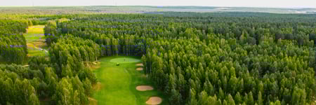 top-view-of-the-golf-course-located-in-a-wooded-ar-2022-11-28-22-29-53-utc-1