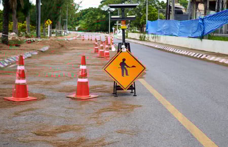 under-construction-sign-on-the-asphalt-road-2022-12-07-04-46-51-utc-scaled